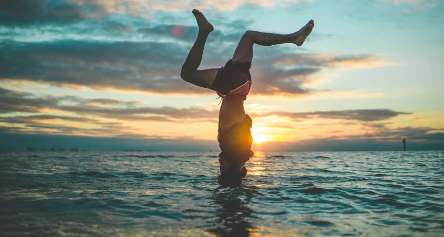 the woman is trying to take a swing in the ocean