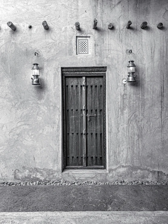 a white building with a door and many small lights