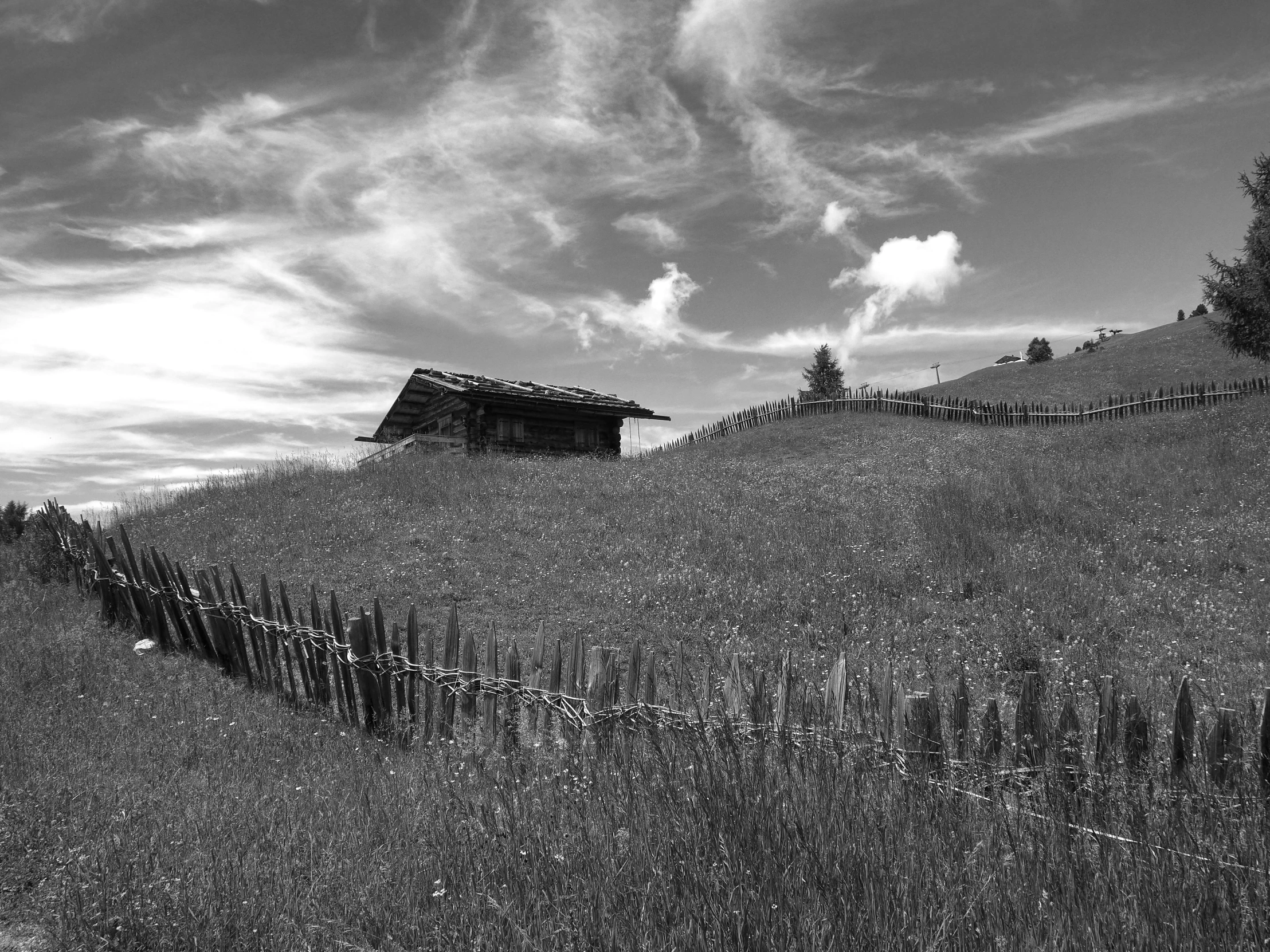 a black and white po of an old building in the hills