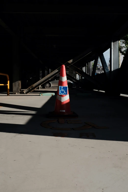 an orange cone with blue and white sticker on it