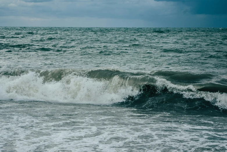 waves roll onto shore in the open ocean