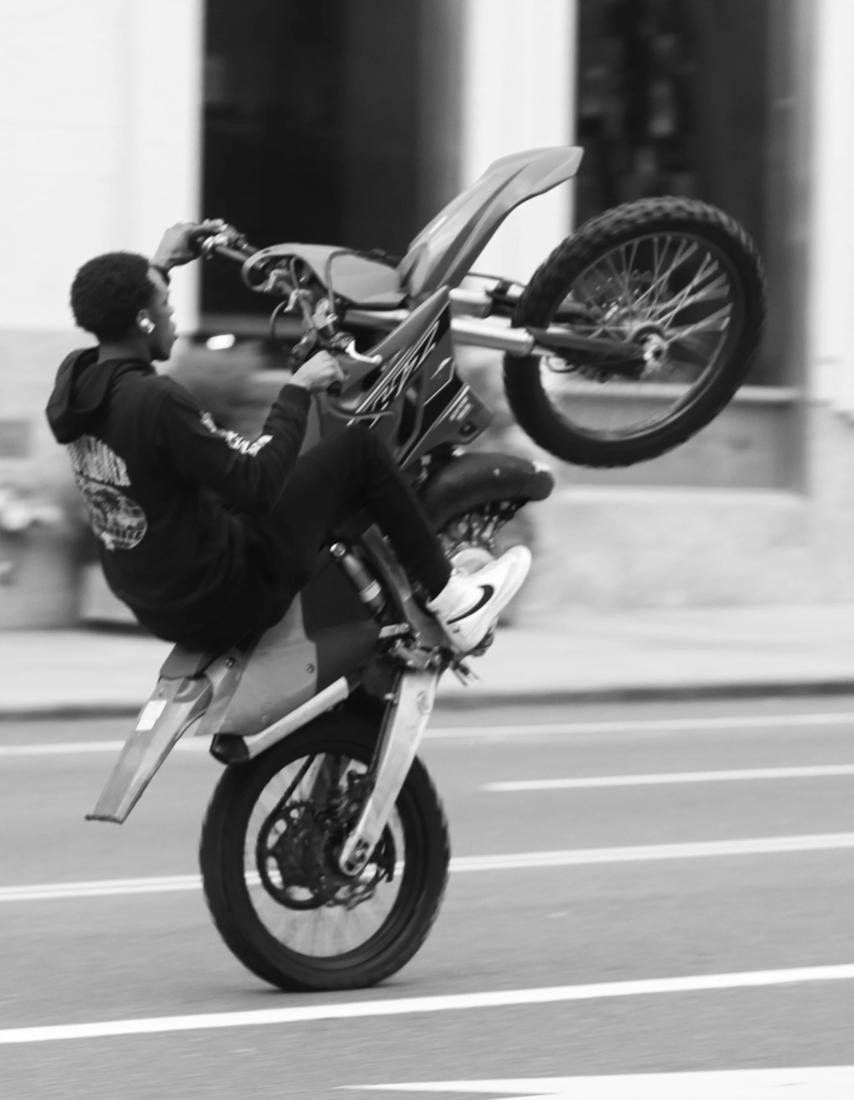 a motorcyclist is jumping up off his motorcycle