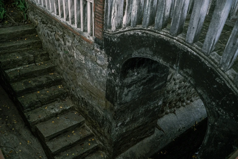 an old rundown building with stairs leading to a balcony