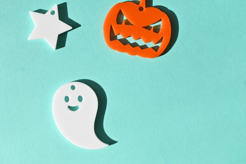 a cutout of a pumpkin with two ghost faces and a star