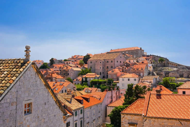 a building next to other buildings with orange roofs