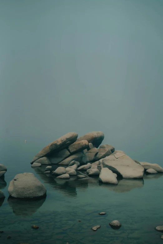 a picture of a lake on a foggy day