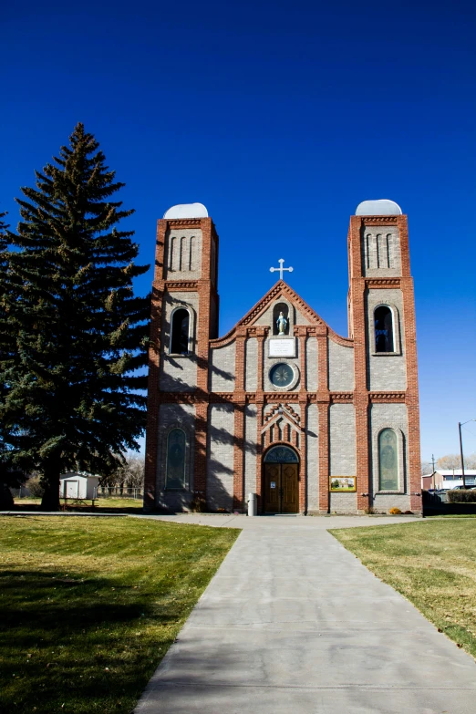 an old style brick church in the middle of a park