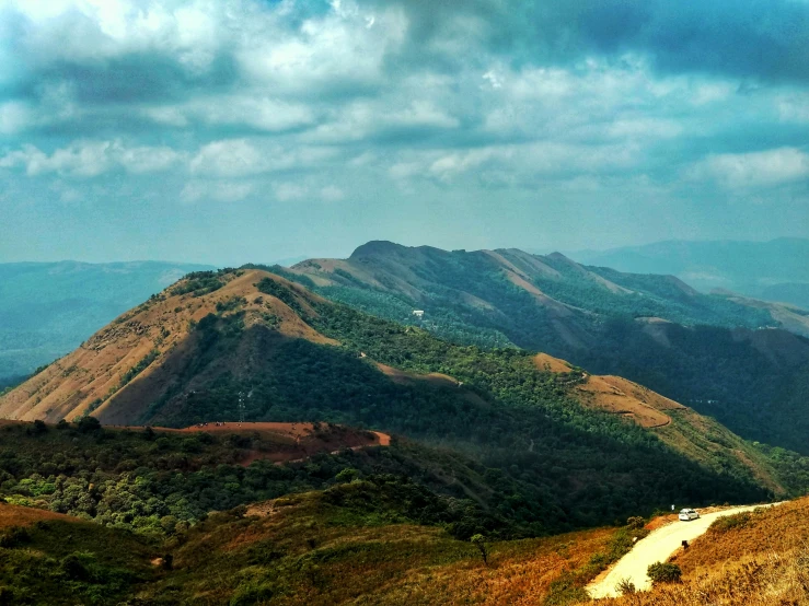 a view of the mountains from a top of a mountain