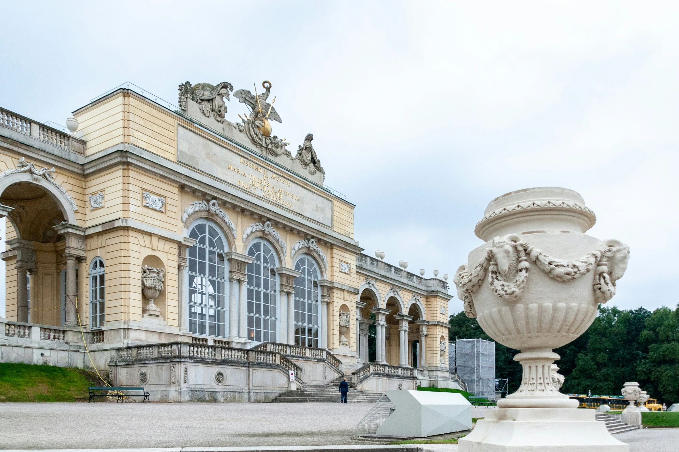 the vase is sitting in the square next to the building