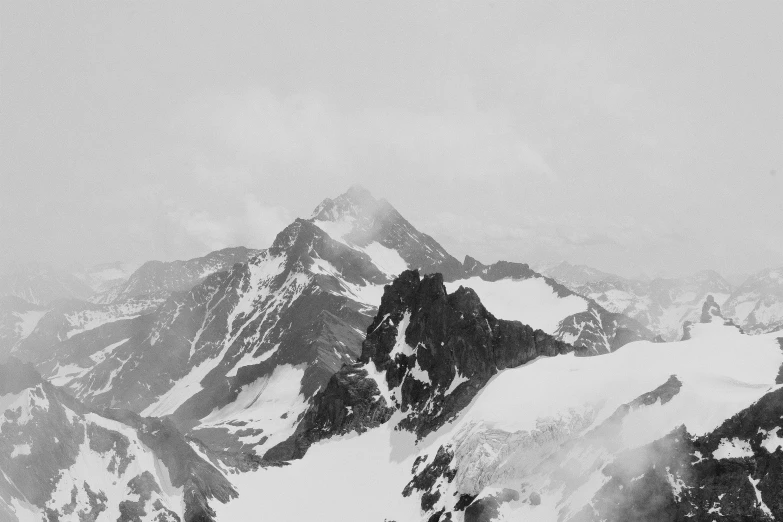 a black and white po of snow covered mountains