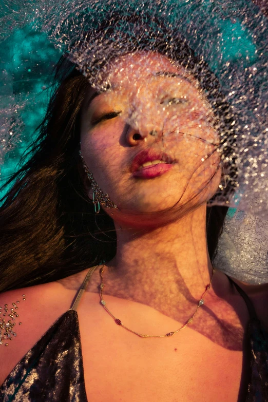 a close up view of a woman's face with snow flakes on her head