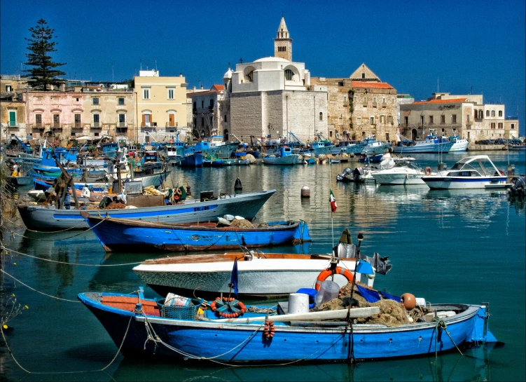 many boats are parked next to each other in the water