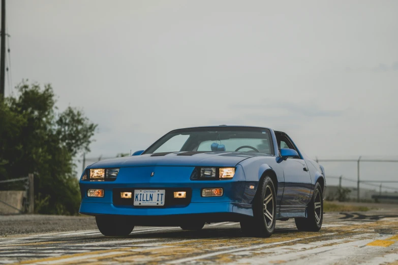 a blue car is parked in the street