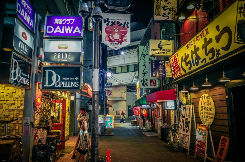 an alley way that has many different signs on it