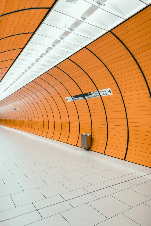 an orange tunnel leading up to the side of a building