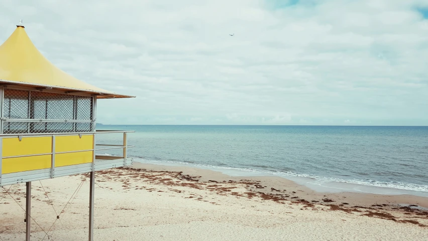 yellow structure and two drawers at the end of beach