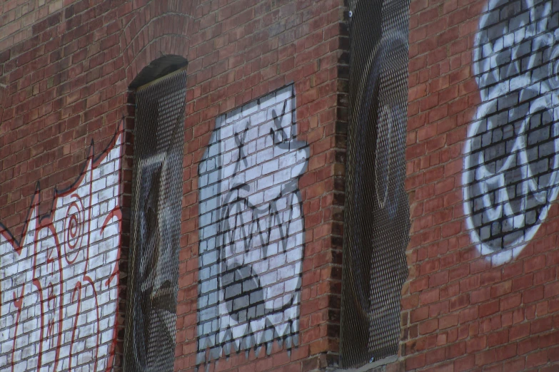 a red brick building with some grafitti on it