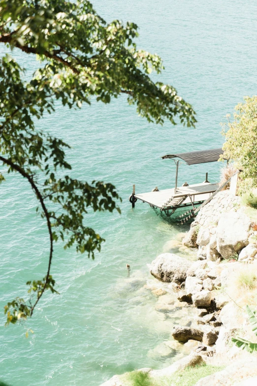 a boat that is out on the water near a rocky shore