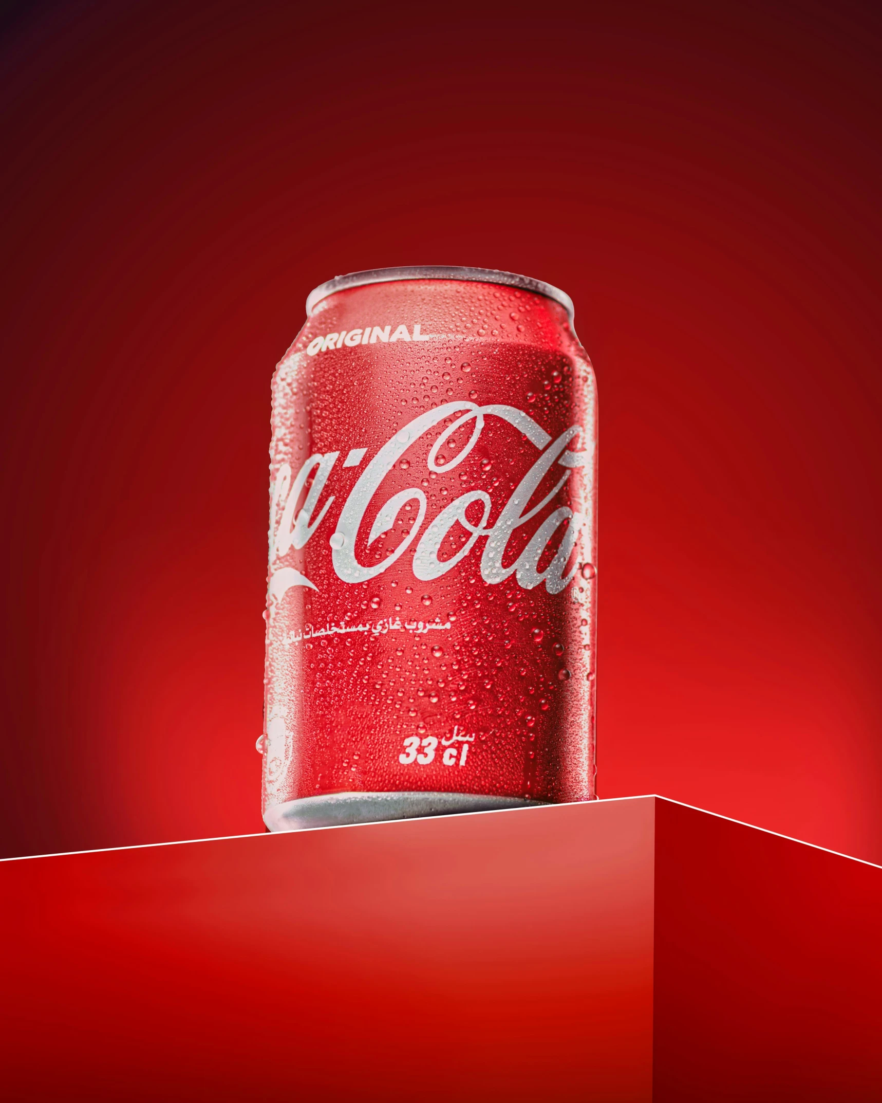 a can of coke is on top of a red surface