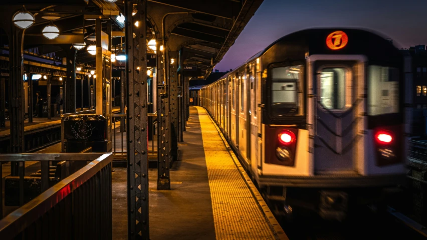 a train pulling into a station at night