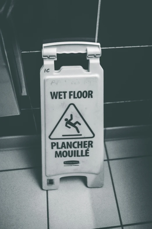 a sign indicating wet floor to walk with the help of a mouse