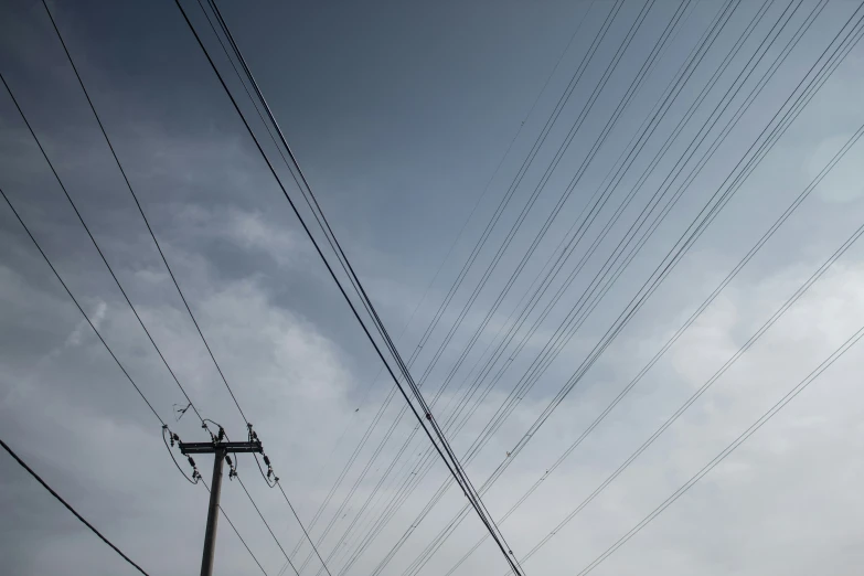 the sky is filled with electrical lines and power poles