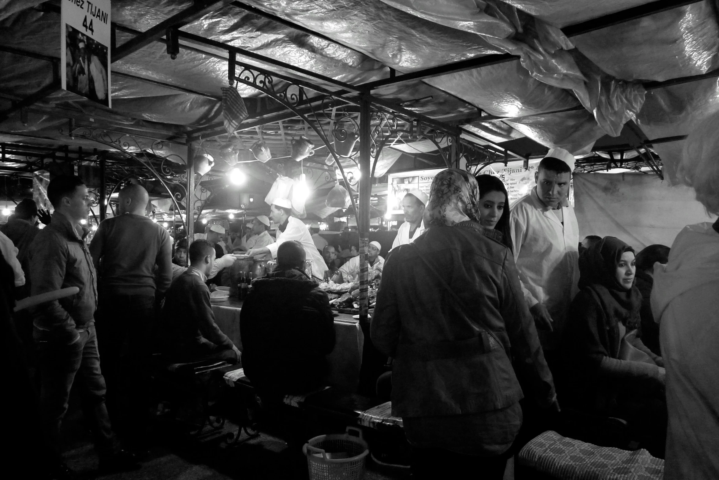 black and white image of people at a food vendor