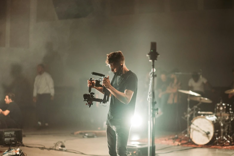 a person standing on a stage with a camera