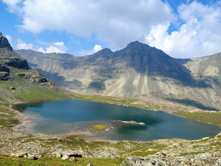 a lake sits in the middle of mountains