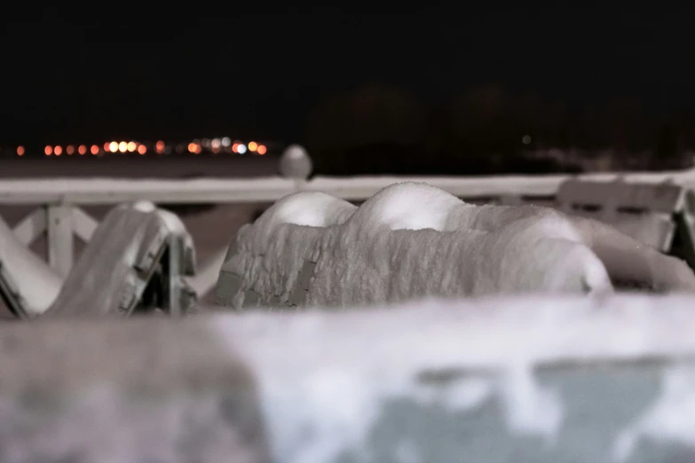 two white snowman in front of a large building