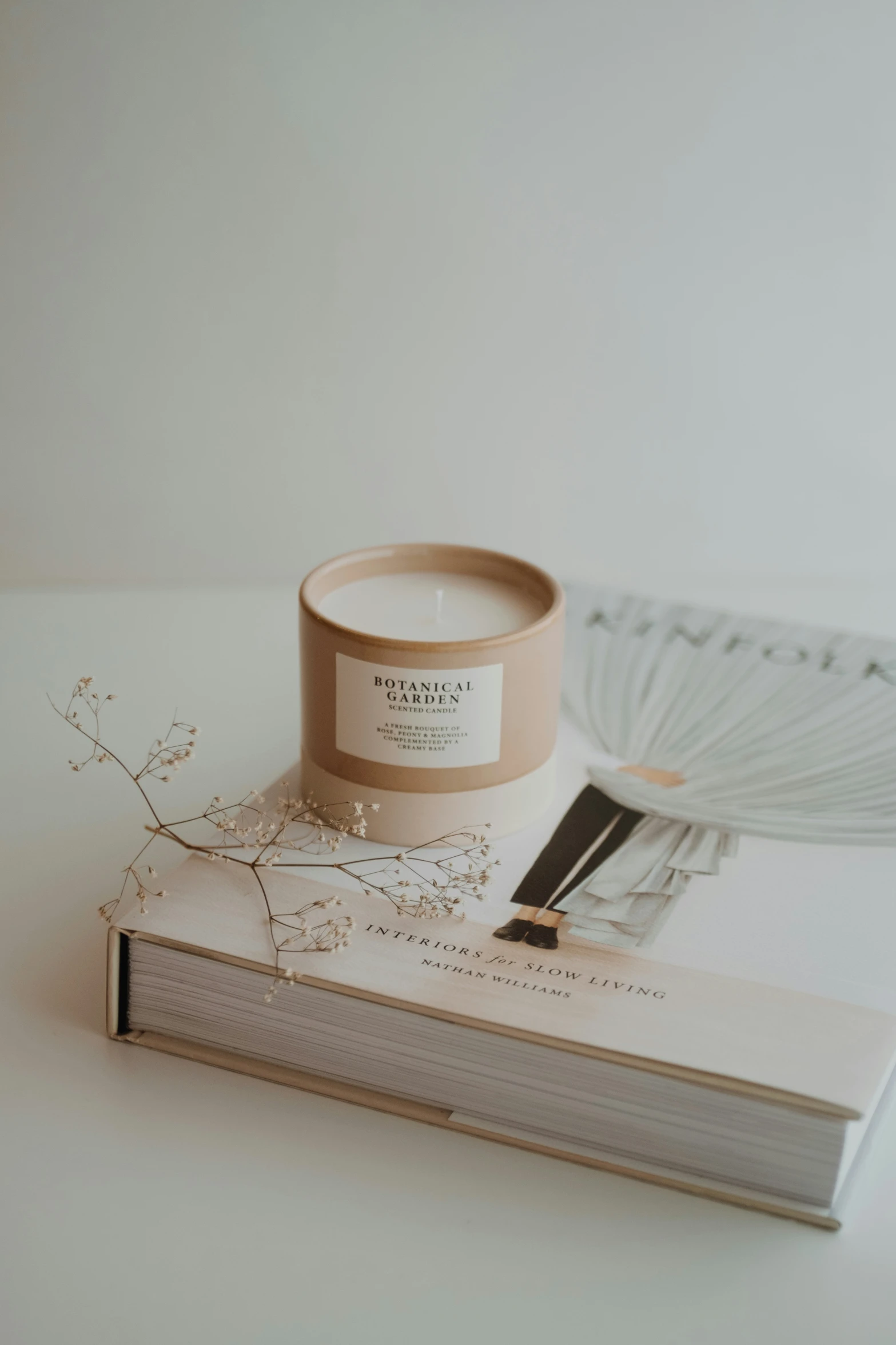 an empty candle sitting on top of a book