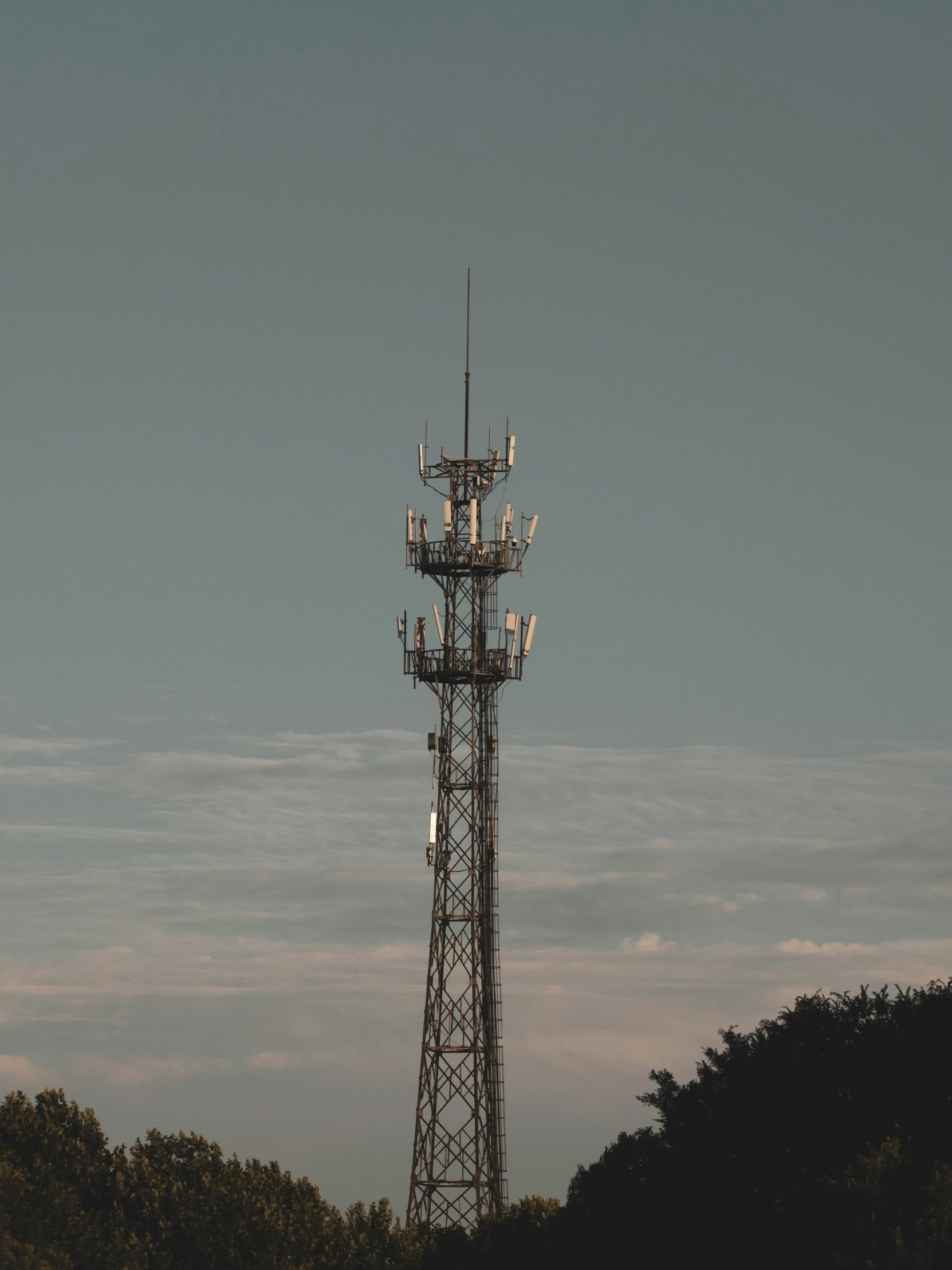 several cell towers with cell phones atop one of them