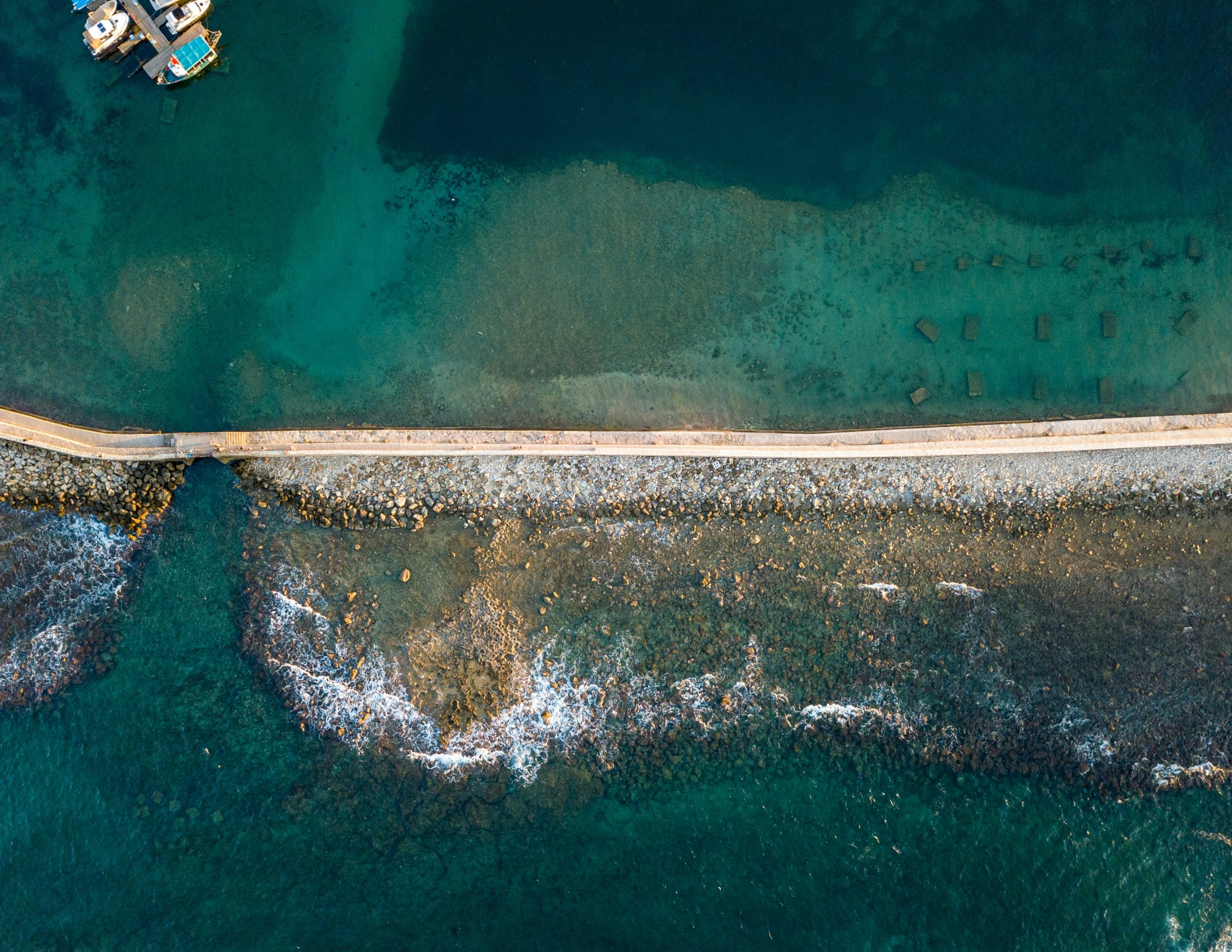 a boat sits on the shore near water