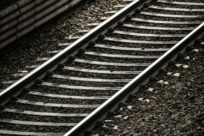 looking down at two black train tracks on the track