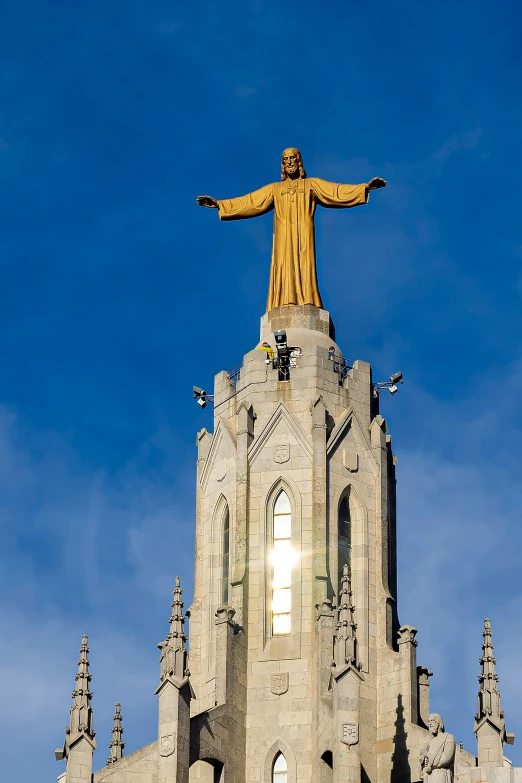 the statue is standing tall near an old building