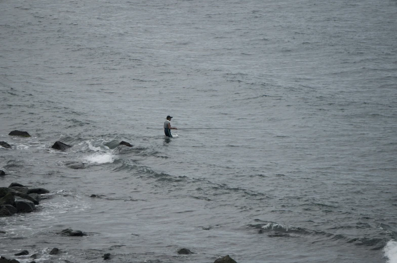 a man standing on top of a large body of water