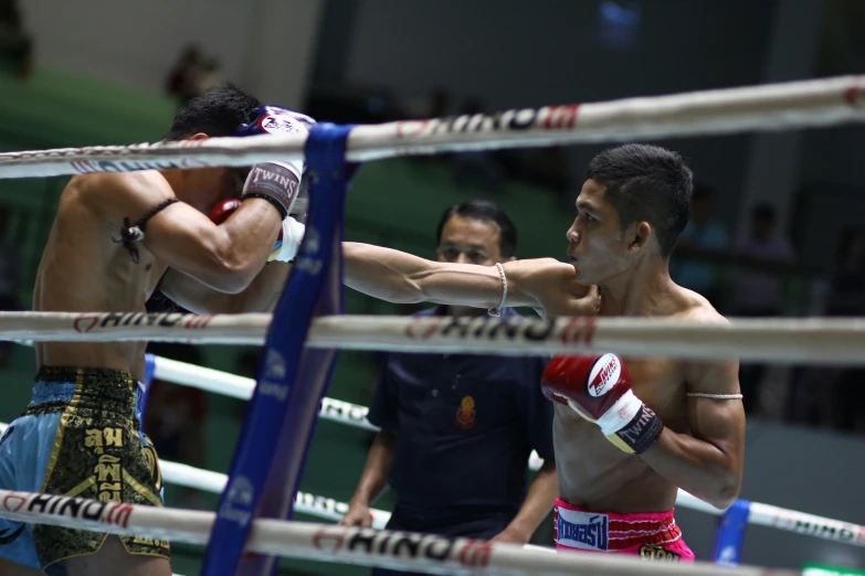 two boxers in red and white trunks are fighting in a ring