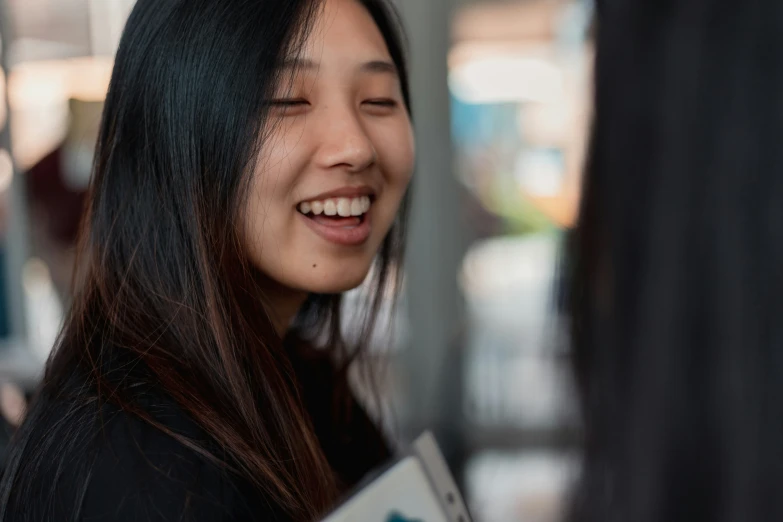 woman laughing and talking while holding soing in her hands