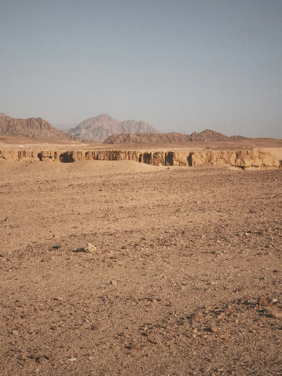 a large desert with mountains in the background