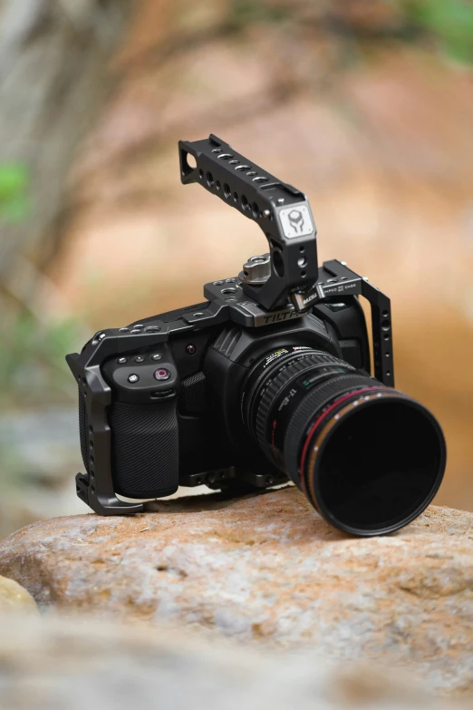 a small camera is resting on a stone