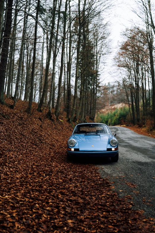 a classic car sits on the side of a road