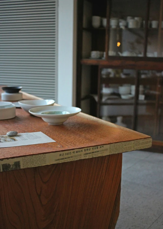 three empty white plates sitting on a brown table