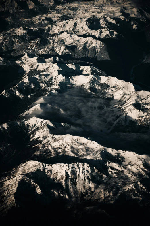 an aerial view of the snow covered mountains