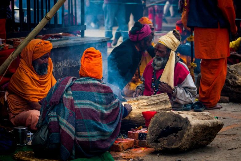 several people gathered around a fire in the street