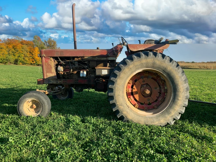 a tractor that is sitting in some grass