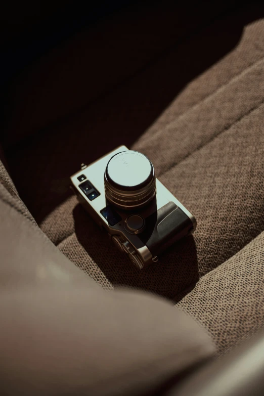 a camera sitting on top of a couch in front of a light