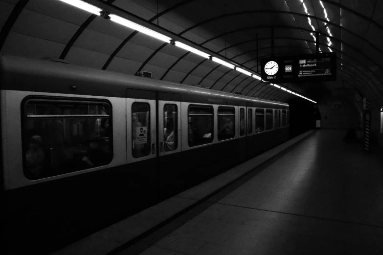 train passing through a subway station in a black and white po