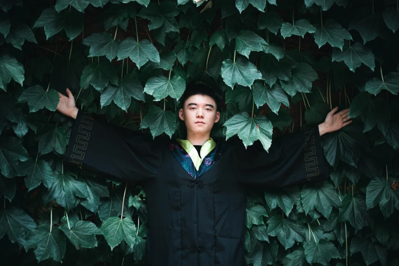 a man standing in front of a green tree