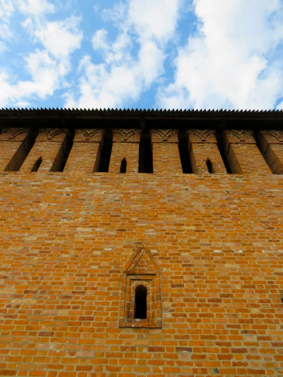 a building made of brick under a blue sky