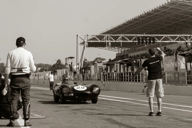 two men standing on the side of a race track